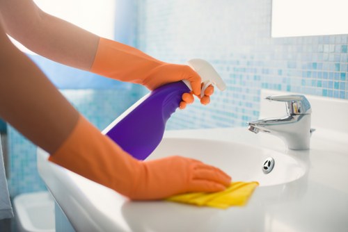 Spot cleaning a fabric sofa stain with microfiber cloth
